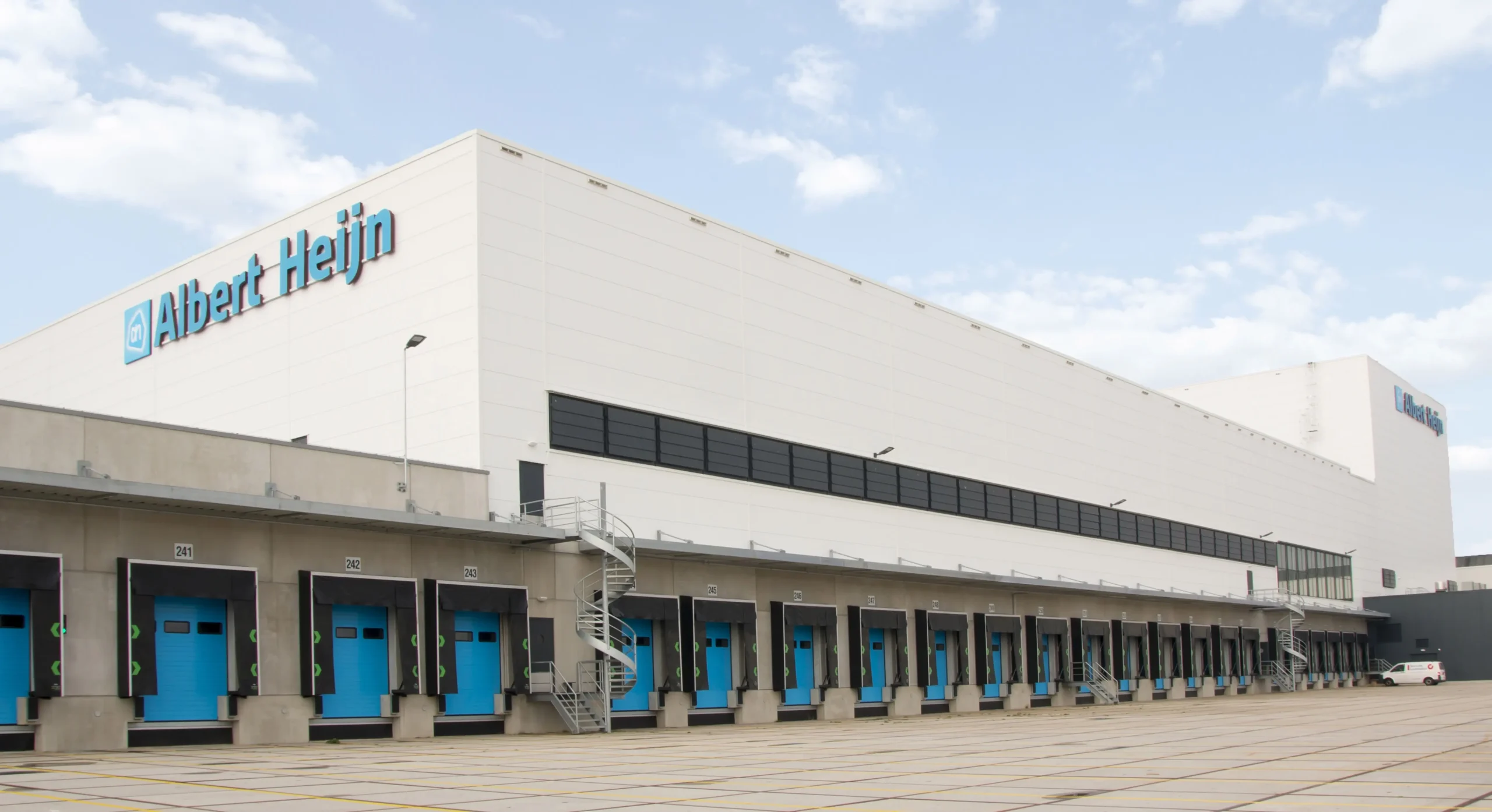 Exterior view of the Albert Heijn distribution center with multiple loading docks.