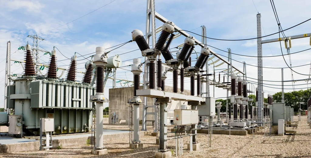 Electrical substation containing high-voltage equipment and transformers.