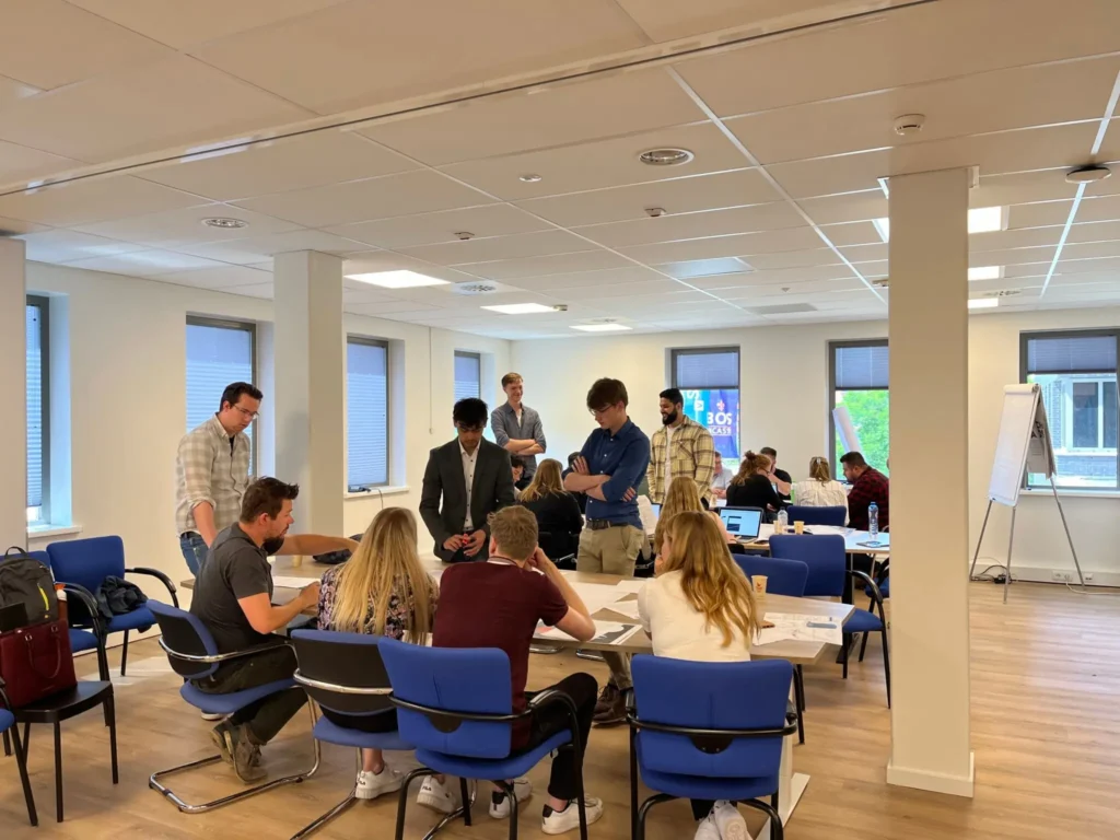 A group of students and professionals engaged in a collaborative meeting at a Vicoma student association event.